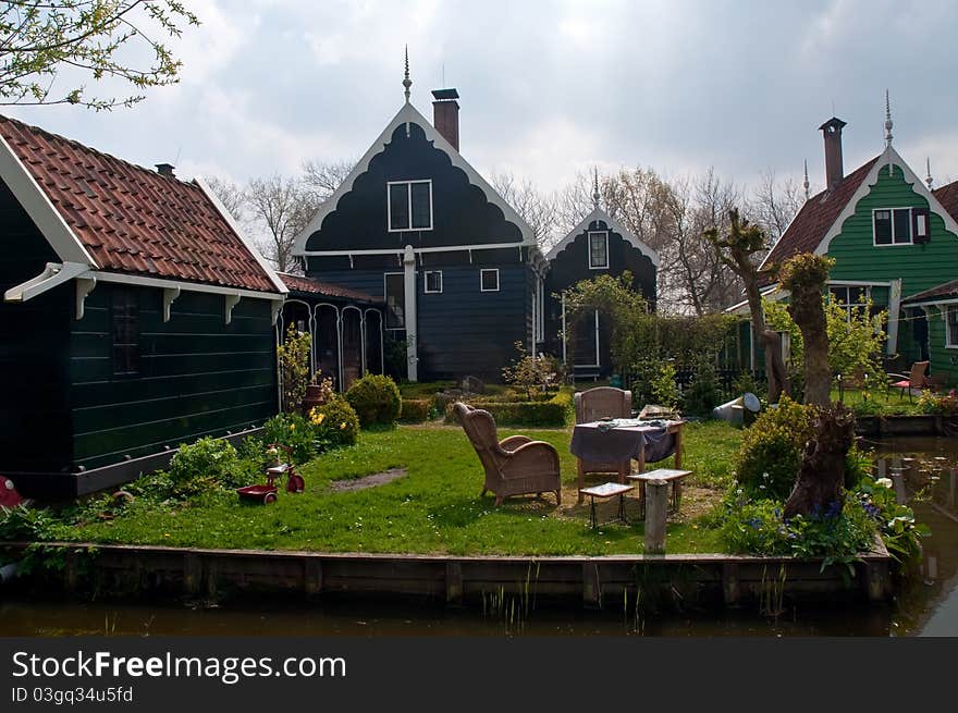 Typical Dutch landscape - houses along the canal. Typical Dutch landscape - houses along the canal.