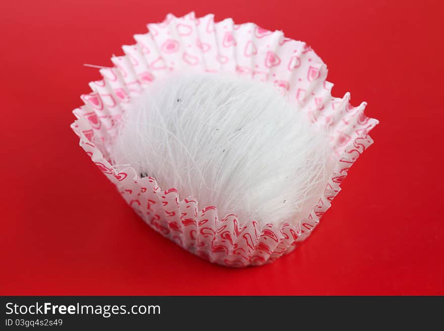 A dragon beard candy on red background.