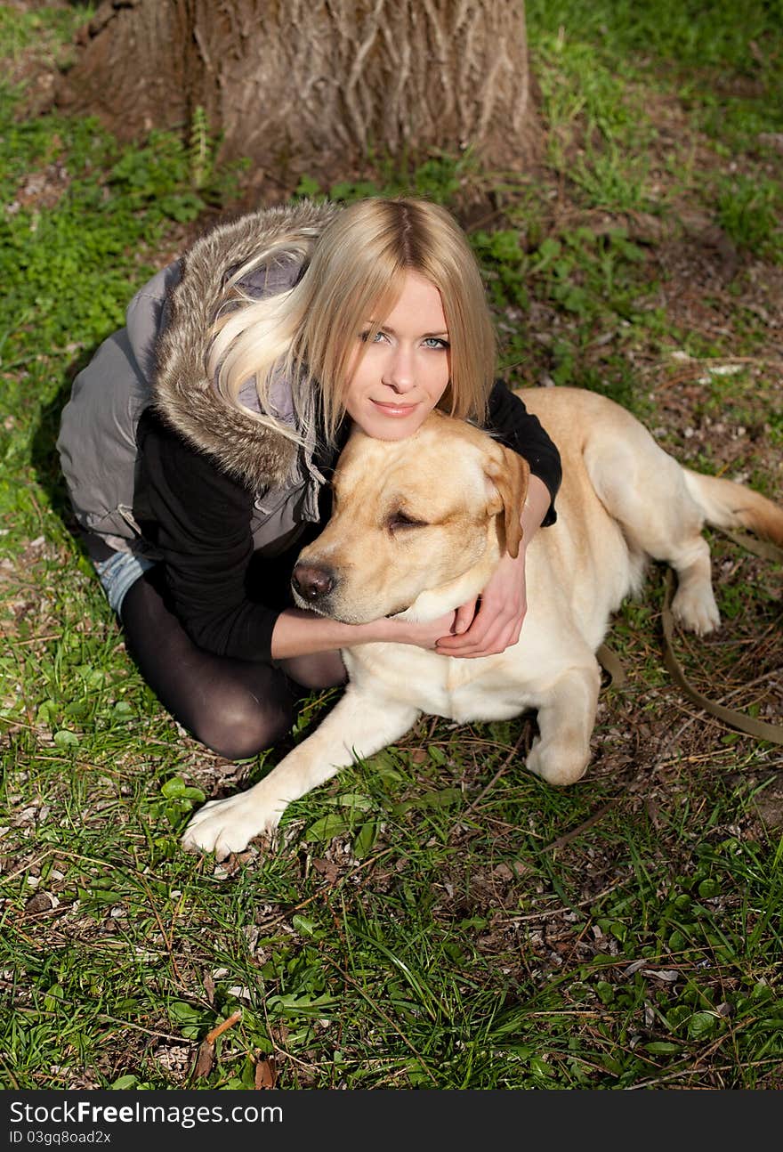 Outdoor shot of beautiful cheerful woman with dog in the park. Outdoor shot of beautiful cheerful woman with dog in the park