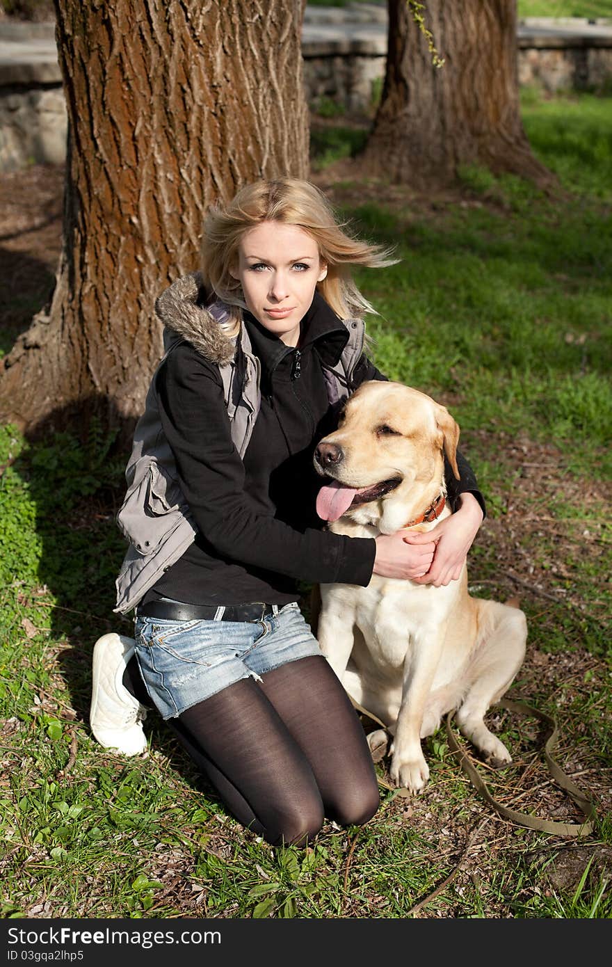 Beautiful Woman With Dog In The Park