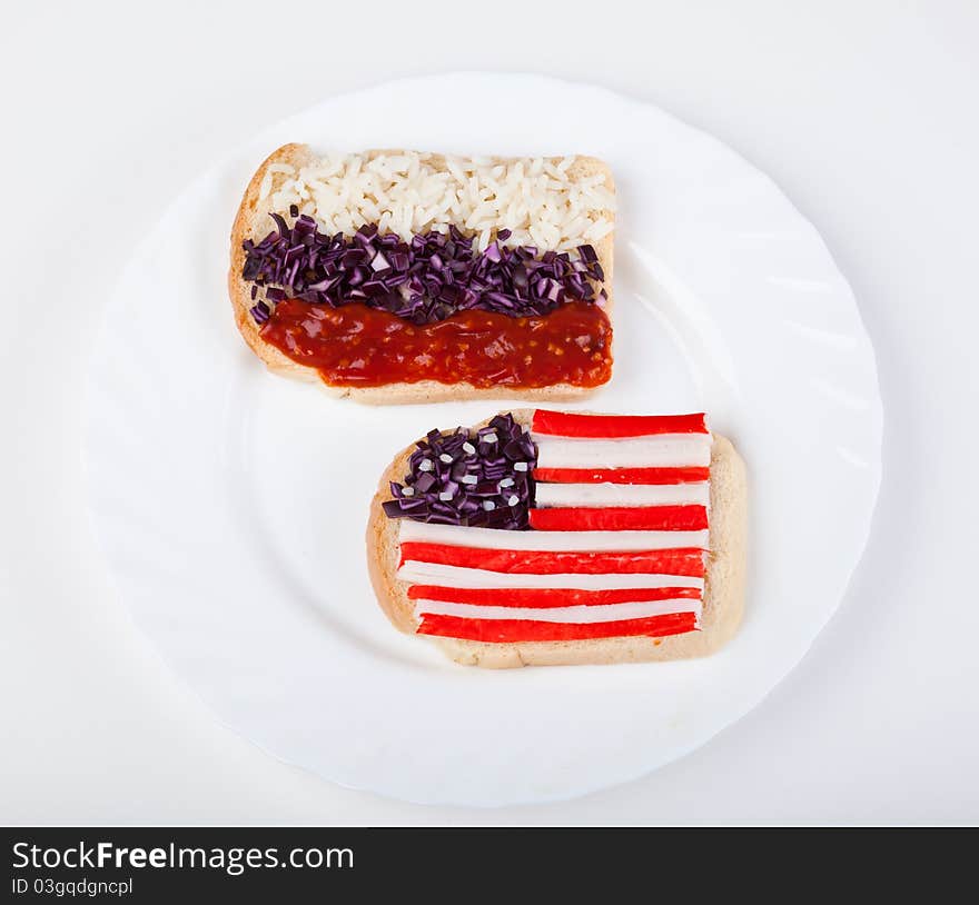 Sandwiches with flags of two countries on plate