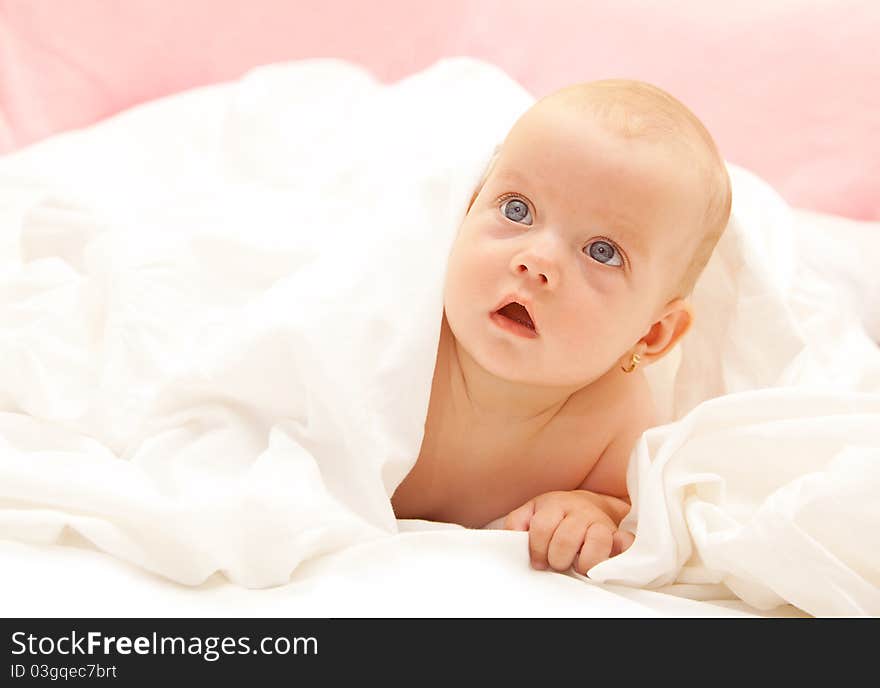 Little cute girl under the pillow. Little cute girl under the pillow