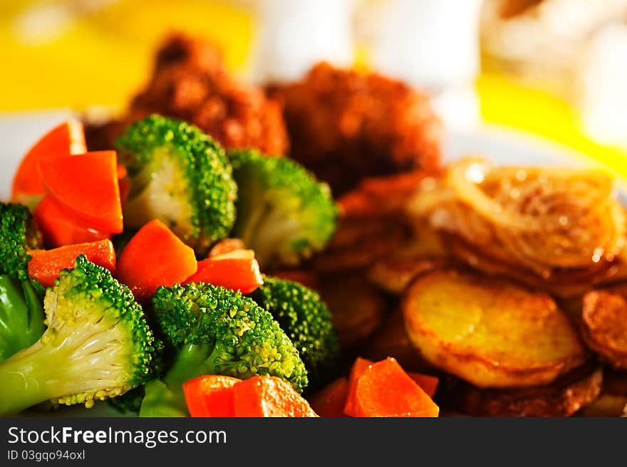 Fried potatoes broccoli carrots and roasted chicken. Fried potatoes broccoli carrots and roasted chicken