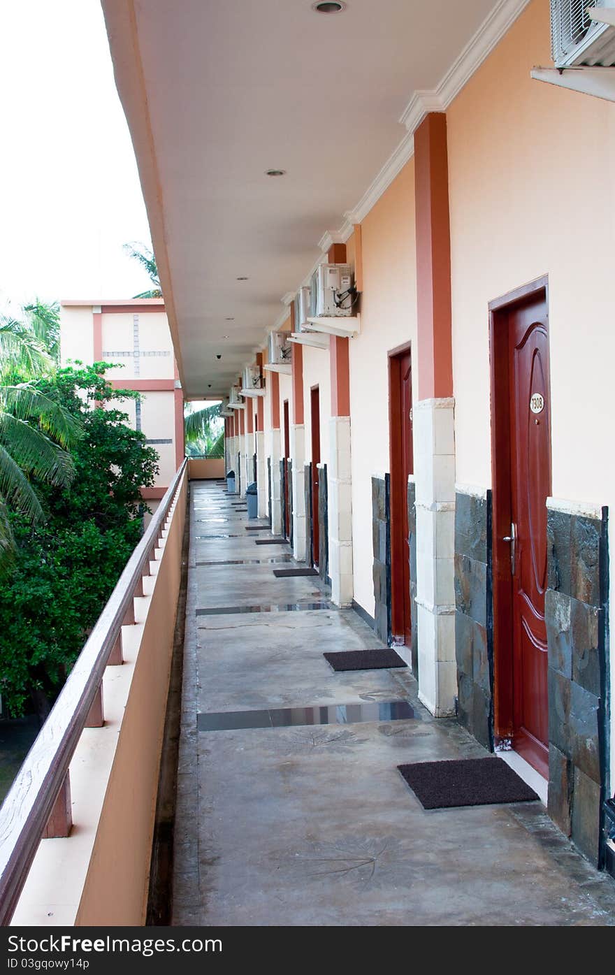 A portrait of hotel corridor with a long perspective view