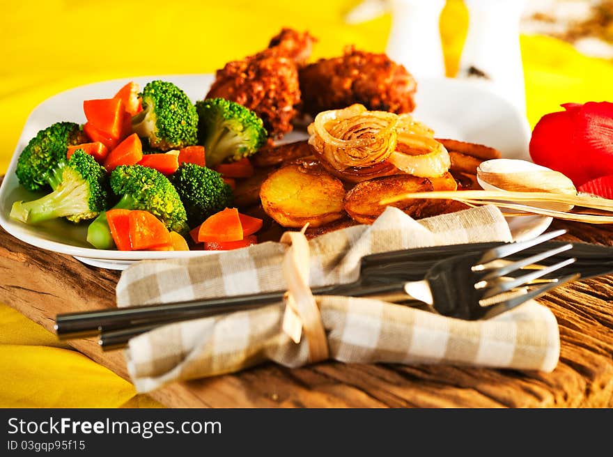 Fried potatoes broccoli carrots and roasted chicken