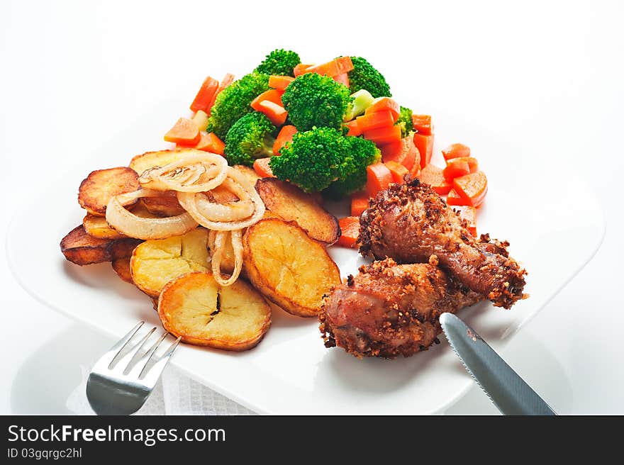 Fried potatoes broccoli carrots and roasted chicken on white background. Fried potatoes broccoli carrots and roasted chicken on white background