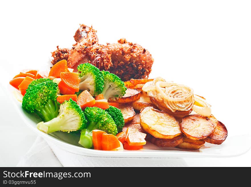 Fried potatoes broccoli carrots and roasted chicken on white background. Fried potatoes broccoli carrots and roasted chicken on white background