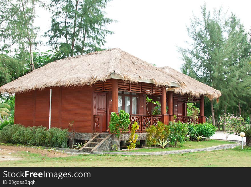 A wooden chalet surrounded by lush greenery