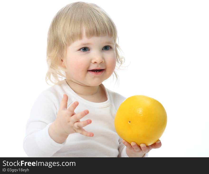 Baby with a ripe grapefruit isolated on white. Baby with a ripe grapefruit isolated on white