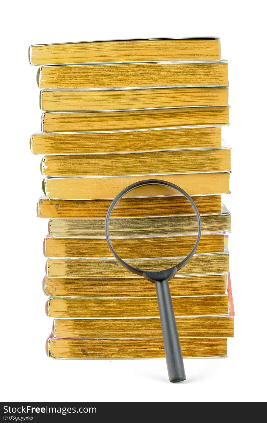 A Stack Of Books And Magnifying Glass