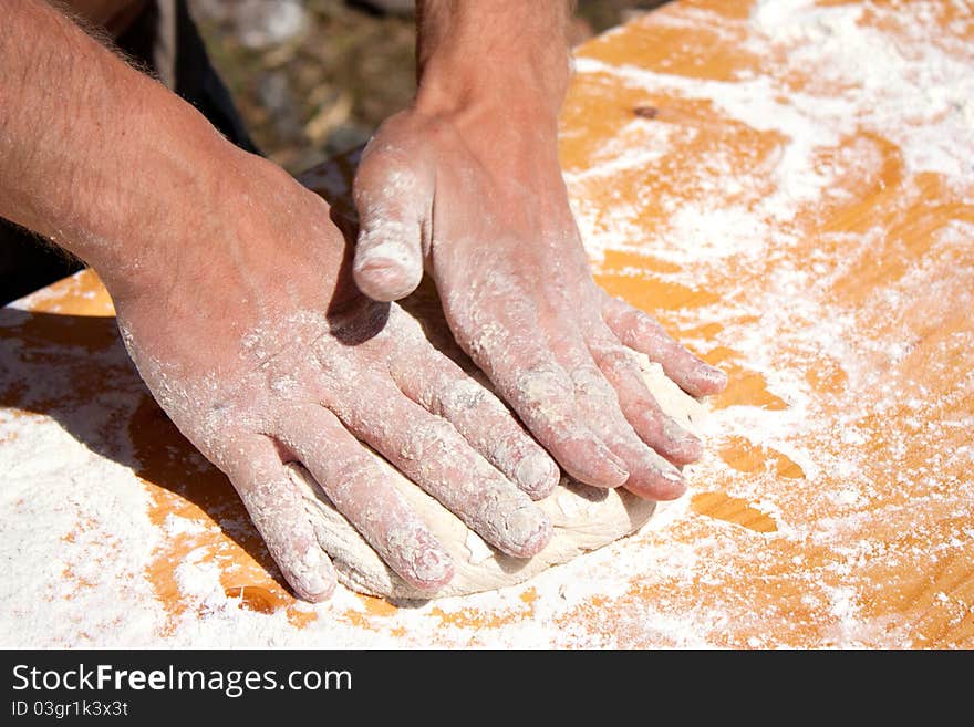 Man hands preparing a little bread