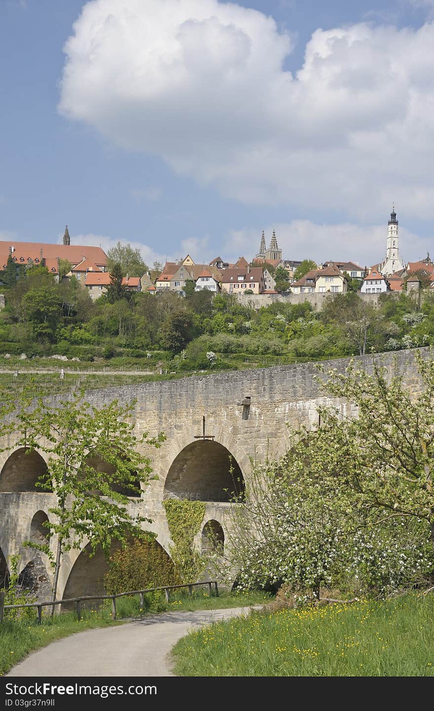 The ancient town of Rothenburg ob der Tauber in the federal state of Bavaria in Germany seen from the valley floor. Rothenburg is very popular with tourists from all over the world. The ancient town of Rothenburg ob der Tauber in the federal state of Bavaria in Germany seen from the valley floor. Rothenburg is very popular with tourists from all over the world.