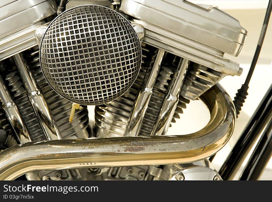 Motorcycle engine closeup showing cycliners, filter and exhaust