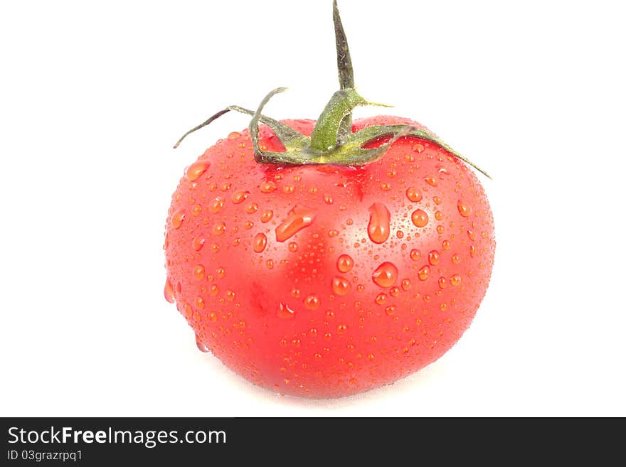 Red tomatoe with water drops isolated over white background.