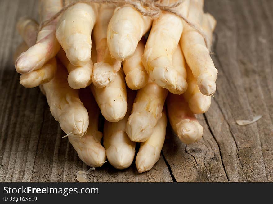 Bunch of fresh white asparagus on old wooden table