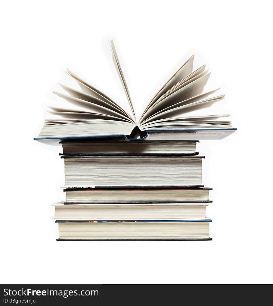 Alarm clock standing on stack of books near open book. Alarm clock standing on stack of books near open book