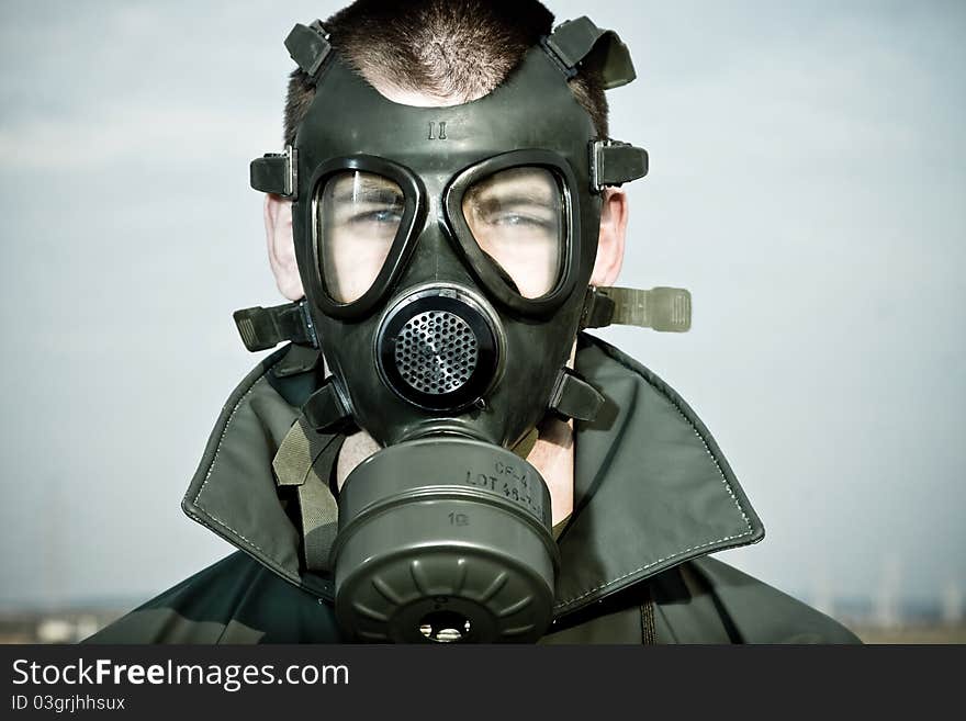 Bizarre portrait of man in gas mask after nuclear disaster