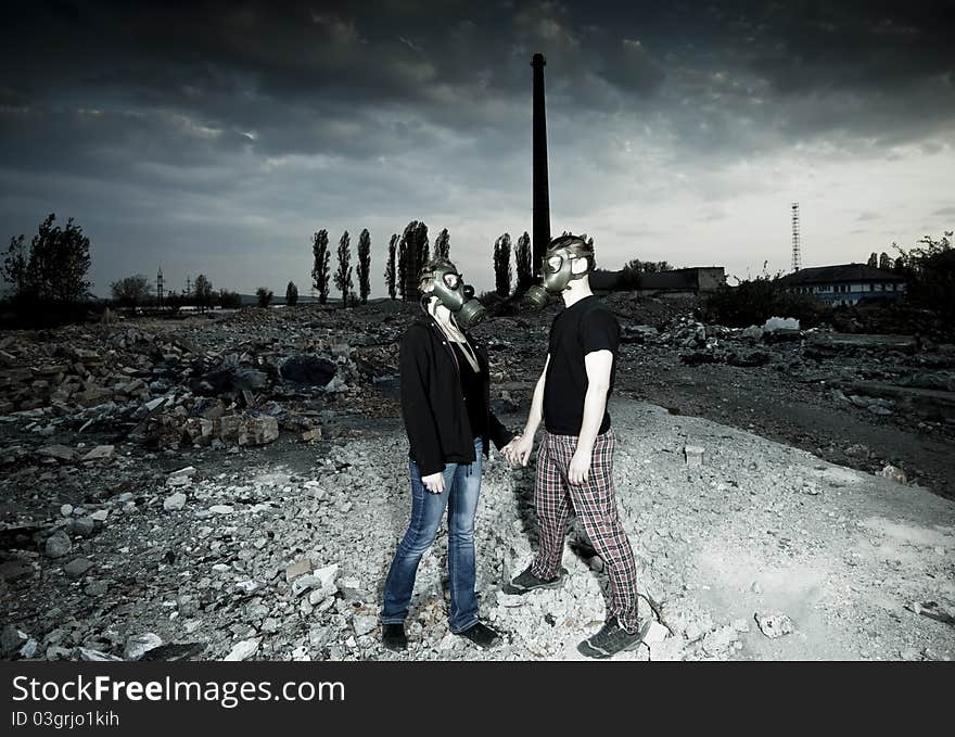 Bizarre portrait of romantic couple with gas masks