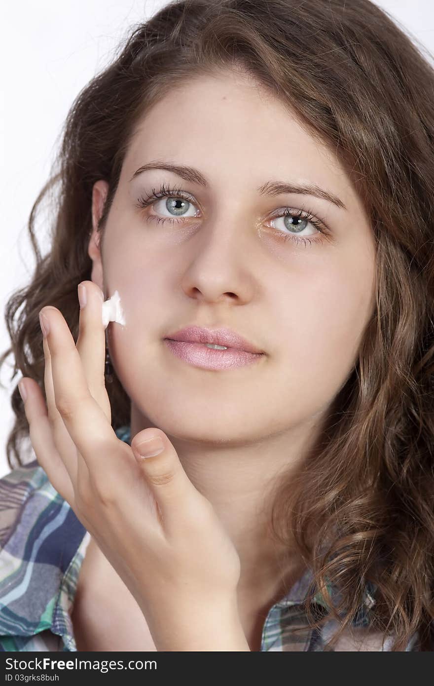 Beauty caucasian young woman applying moisture