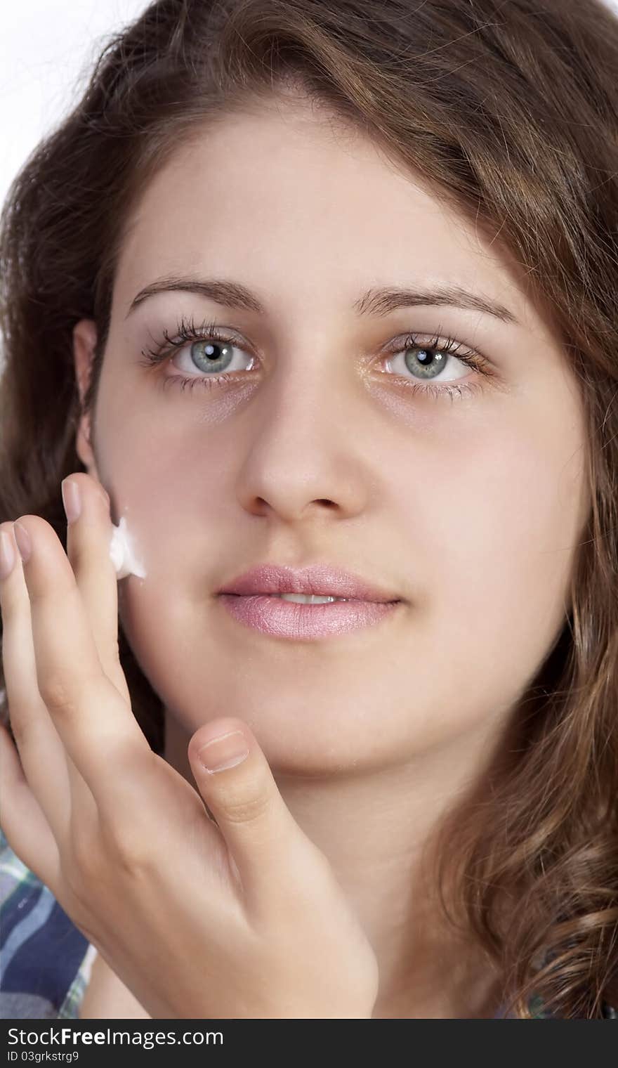 Beauty caucasian young woman applying moisture