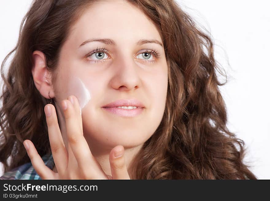 Beauty caucasian young woman applying moisture