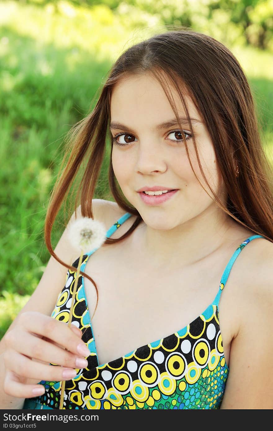 Girl holds in the hand the dandelion. Girl holds in the hand the dandelion