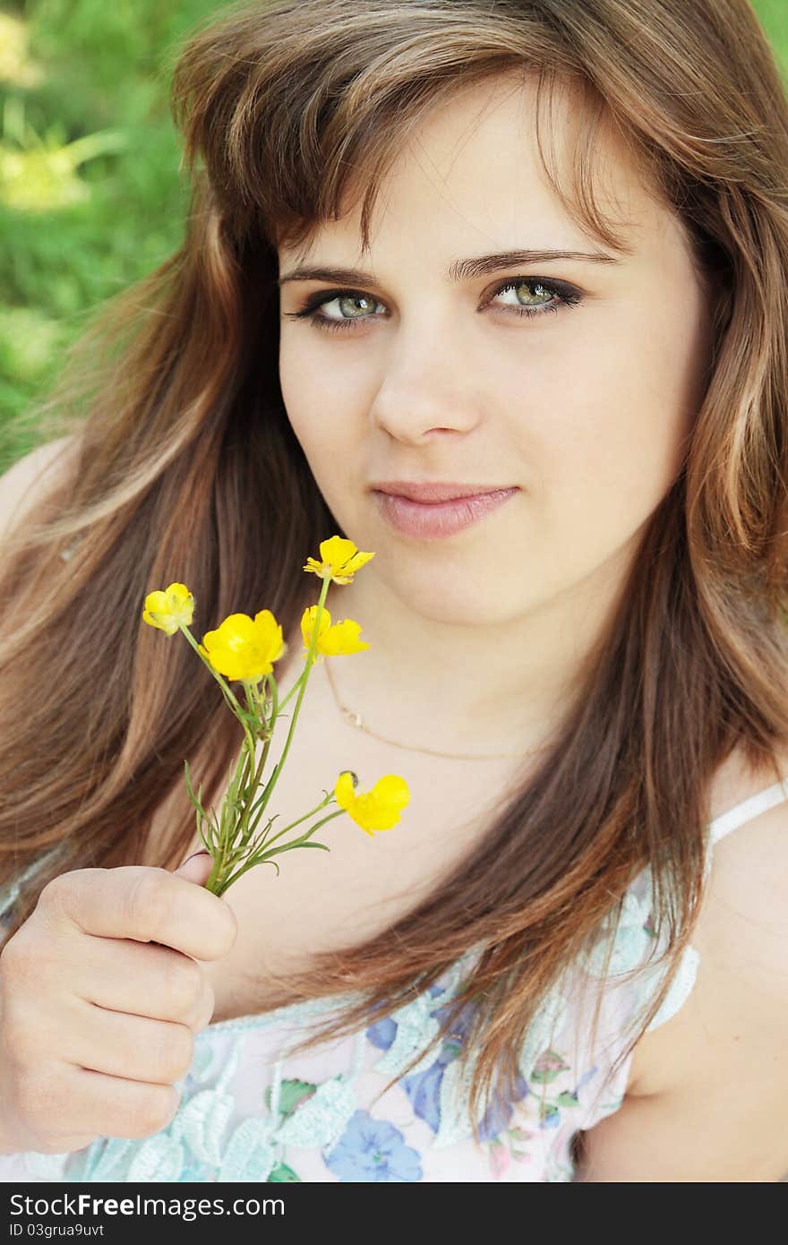 Portrait of young girl with the flower