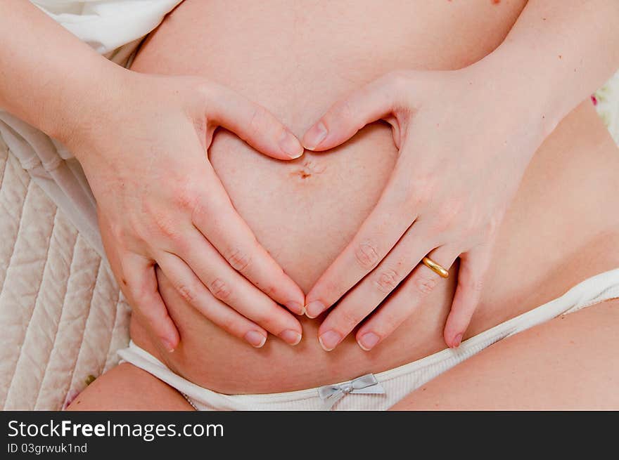 A pregnant girl on uniform background