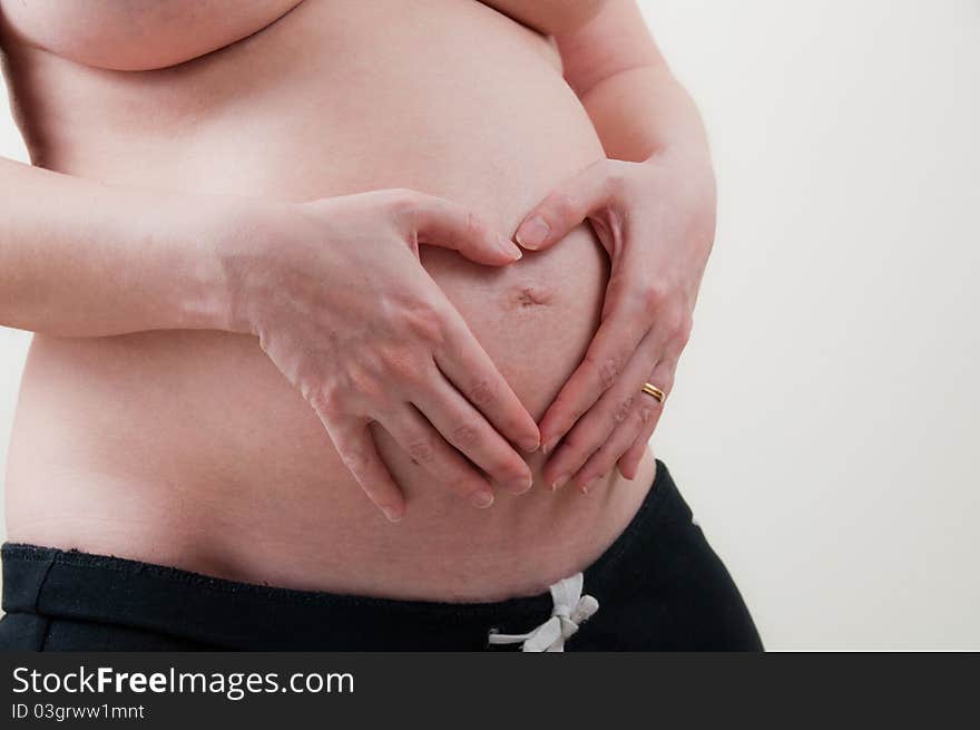 A pregnant girl on uniform background