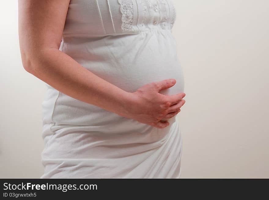 A pregnant girl on uniform background