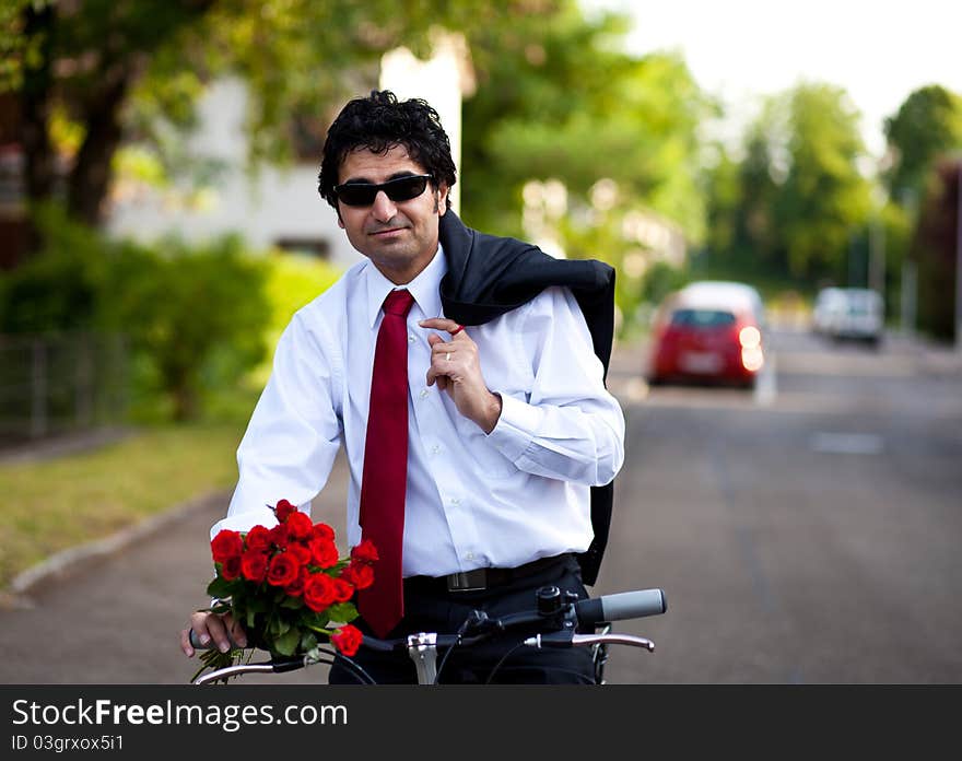 Businessman with bouquet of red roses holding a jacket on a shoulder. Businessman with bouquet of red roses holding a jacket on a shoulder