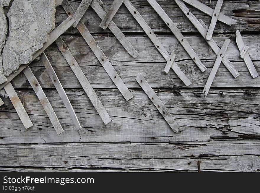 Old wooden wall with part of plaster. Old wooden wall with part of plaster