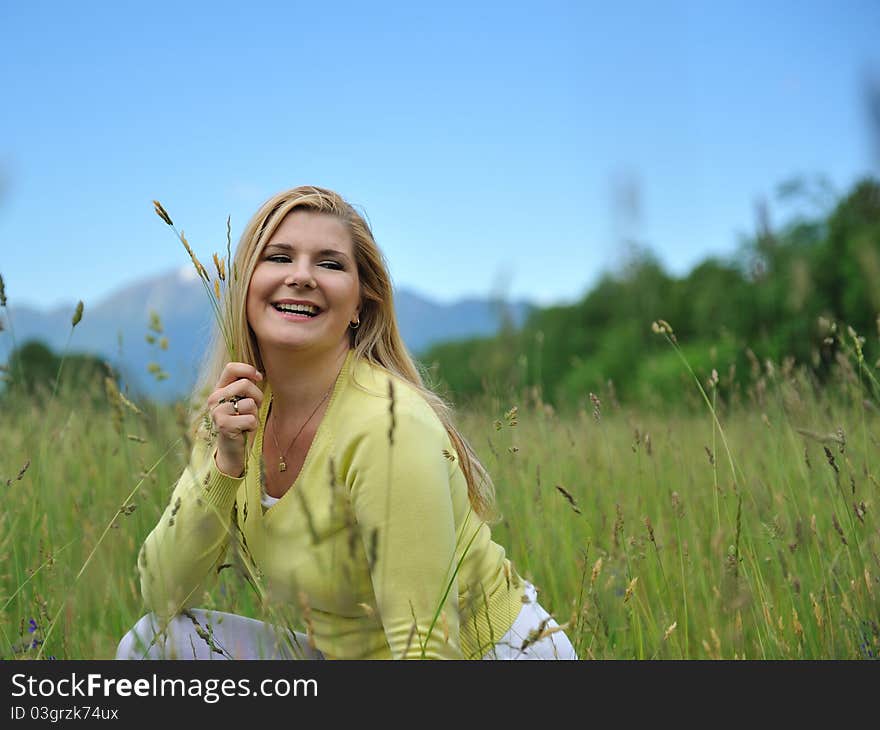 Beautiful natural woman with pure healthy skin outdoors on spring field. Switzerland. Beautiful natural woman with pure healthy skin outdoors on spring field. Switzerland