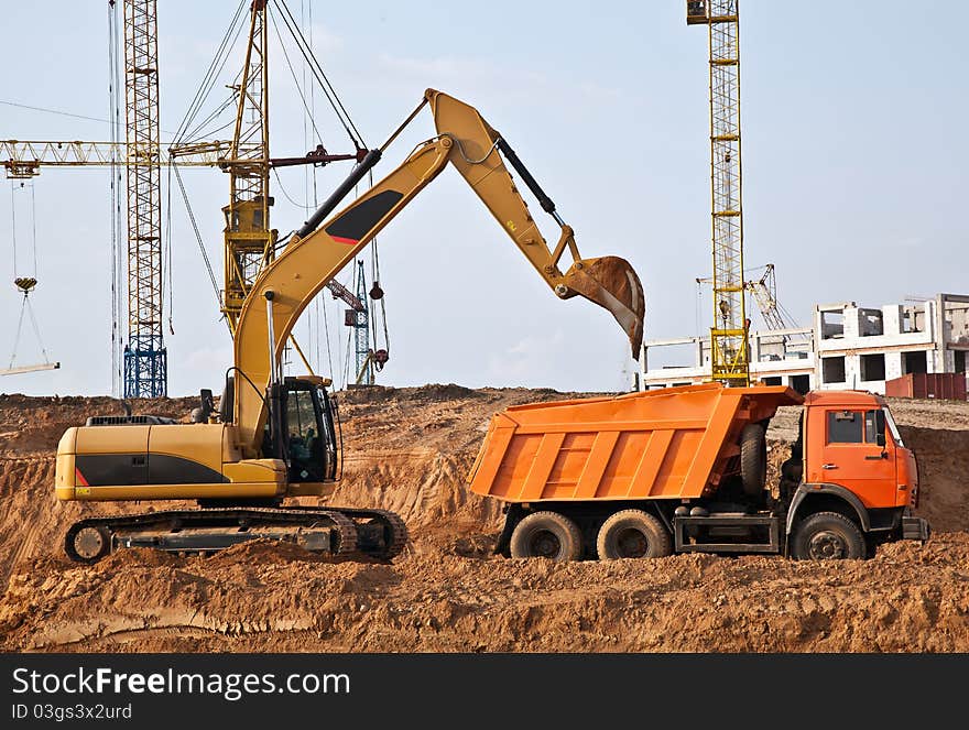 Backhoe loading a dump truck