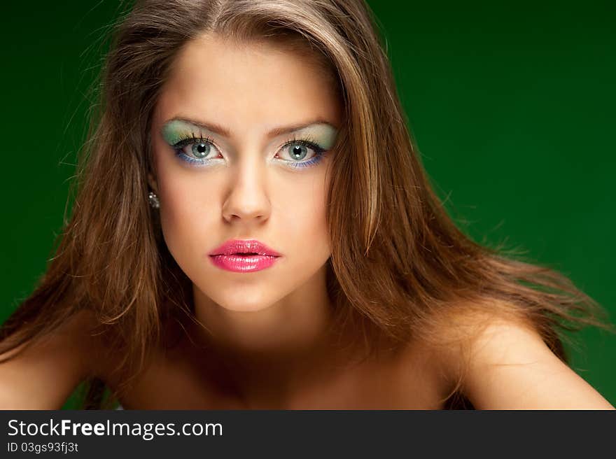 Portrait of a pretty girl on the green background