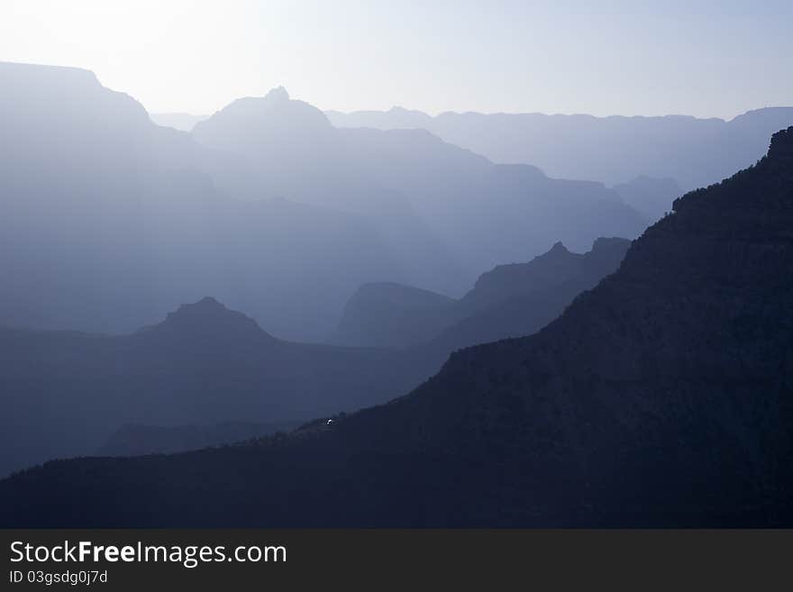 Scenic Layers of the Grand Canyon in the Early Morning with Hikers Cabin Roof Shining in the Lower Middle.