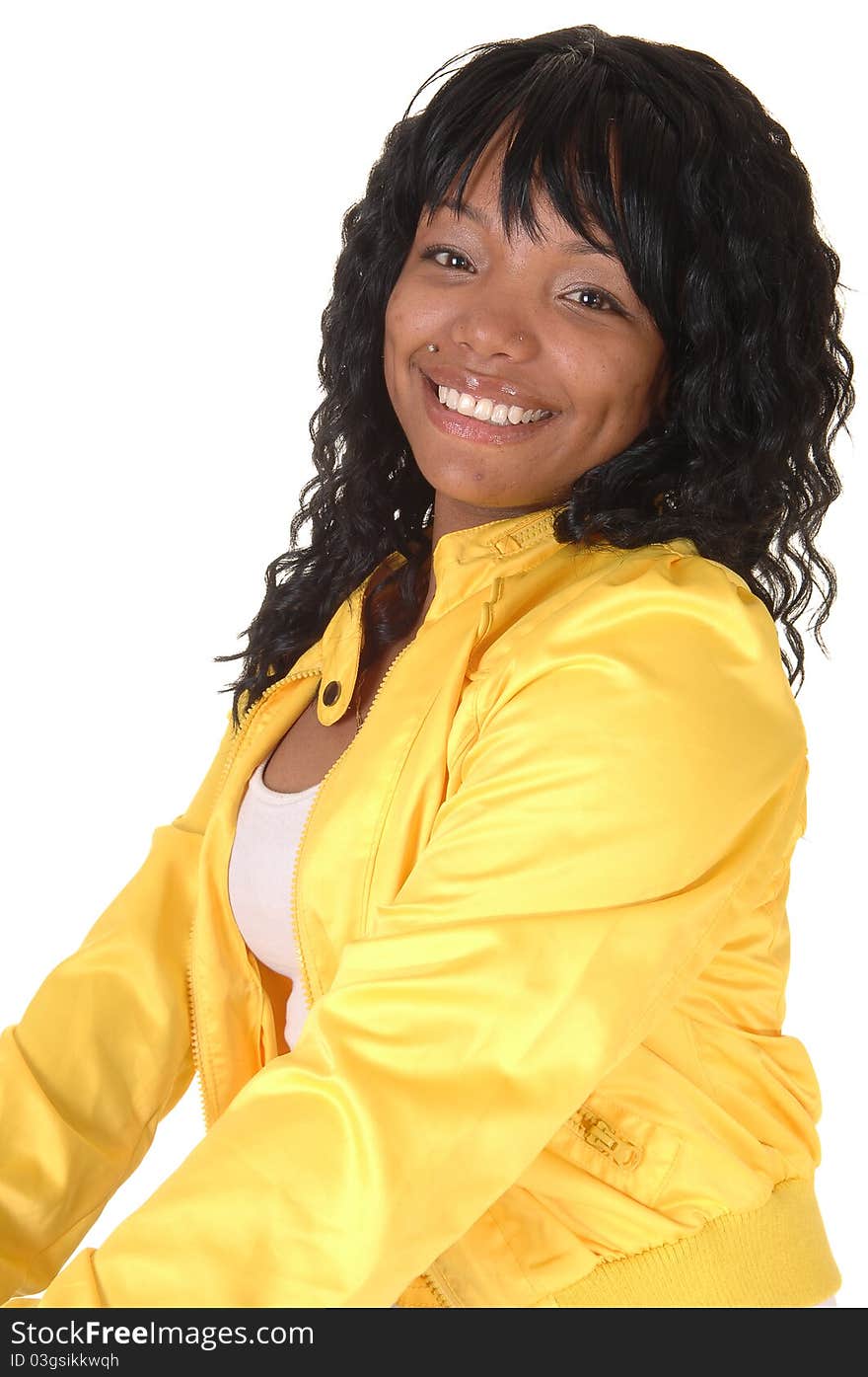 A young pretty African American woman sitting on an chair in white tights and a yellow jacket from the back, looking over her shoulder, for white background. A young pretty African American woman sitting on an chair in white tights and a yellow jacket from the back, looking over her shoulder, for white background.