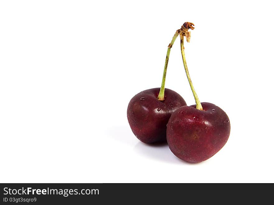 Two cherries with dewdrop on white background