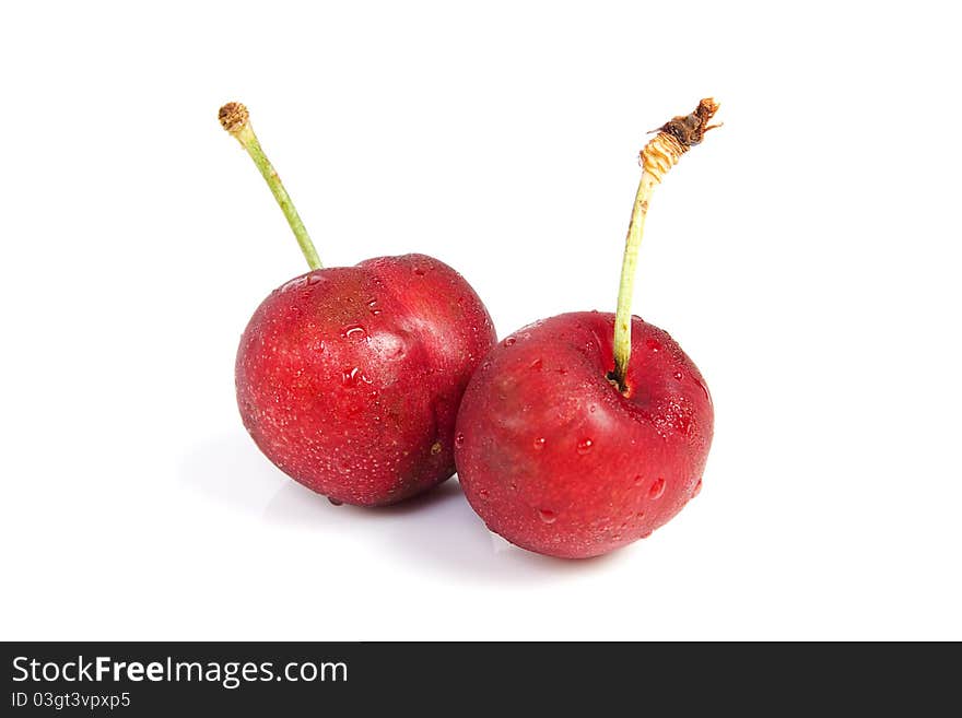 Two cherries with dewdrop on white background