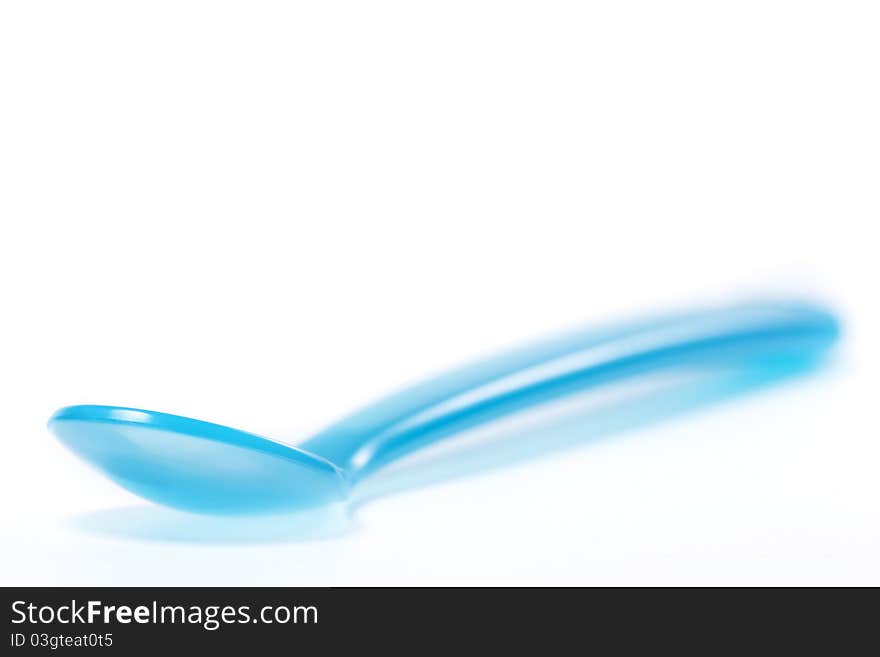 Blue plastic spoon on white background