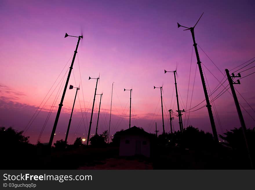 Silhouette turbine wind mill in sunset background