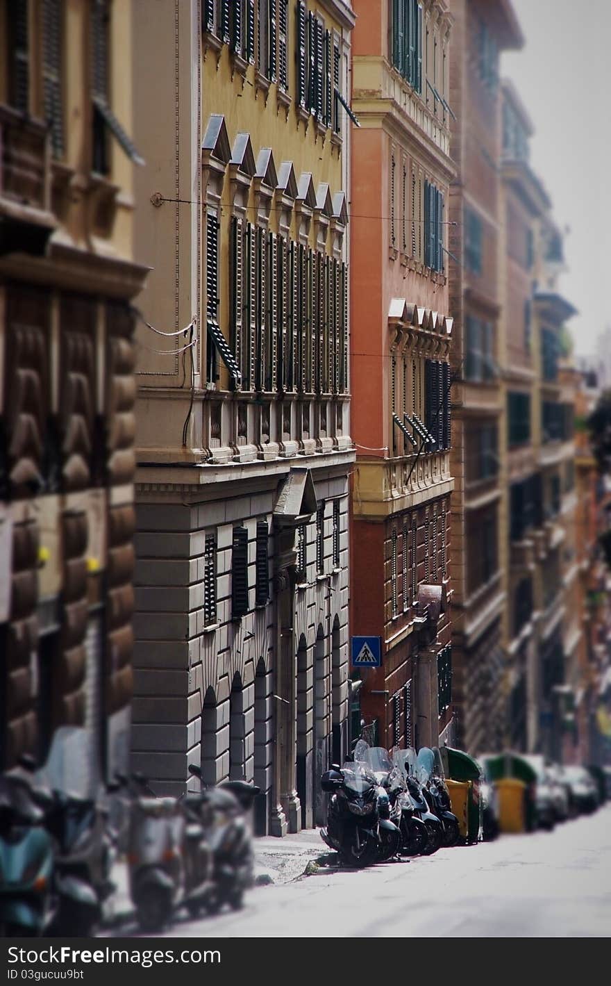 Quiet city street with parked cars in Genoa, Italy