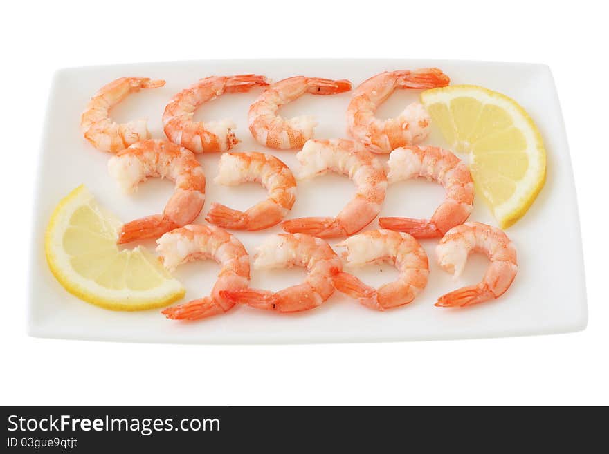 Boiled shrimps with lemon on a plate