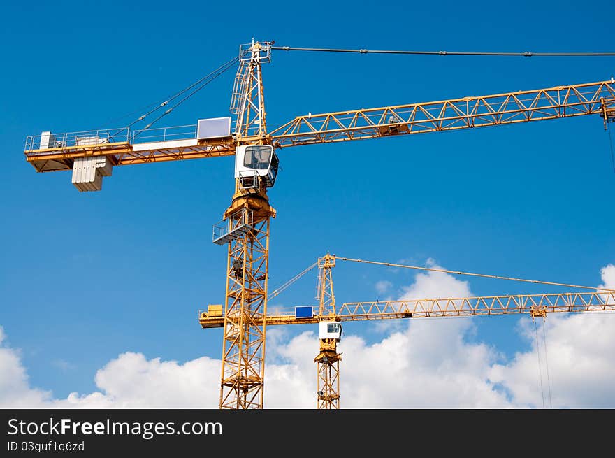 Yellow cranes with a blue sky as a background