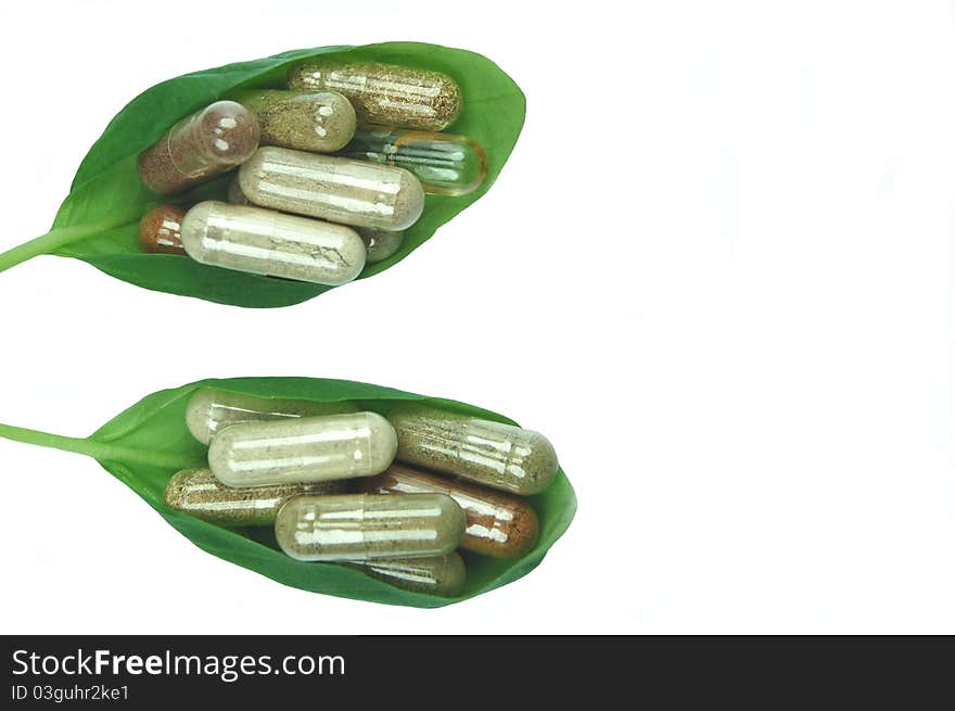 Herbal capsules in green basil leaves. Herbal capsules in green basil leaves