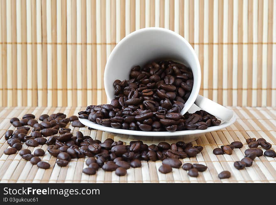 White cup and saucer with coffee beans. White cup and saucer with coffee beans