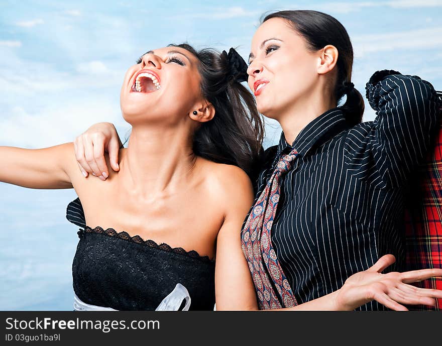 Two beautiful happy females hugging and laughing with excitement. Two beautiful happy females hugging and laughing with excitement