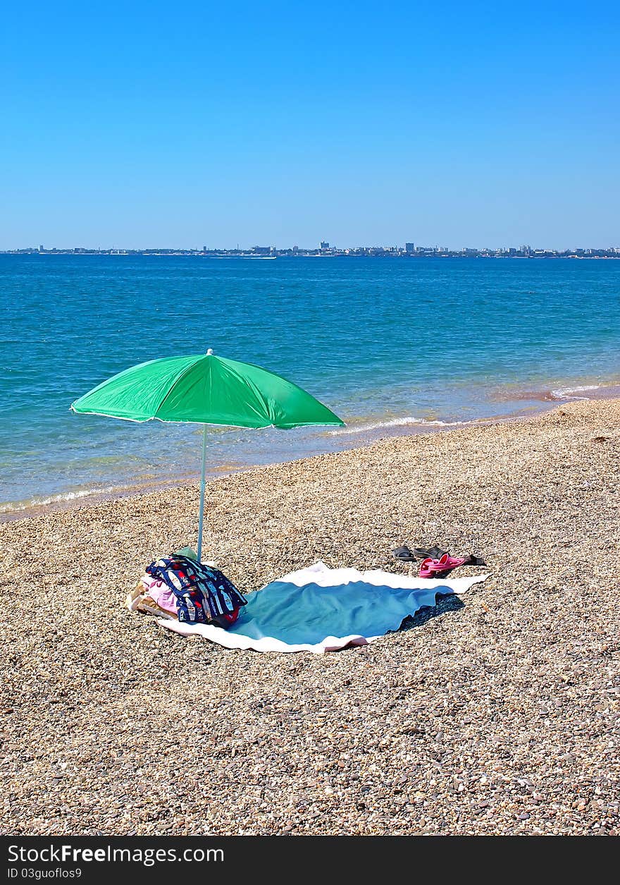 Umbrella and clothes on a beach