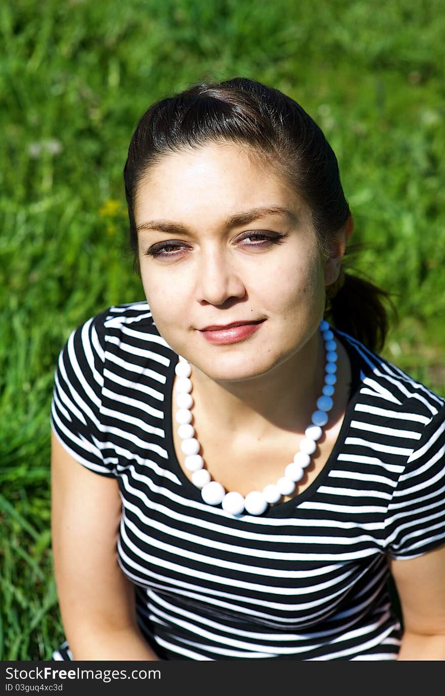 Oriental girl on the grass field in summer