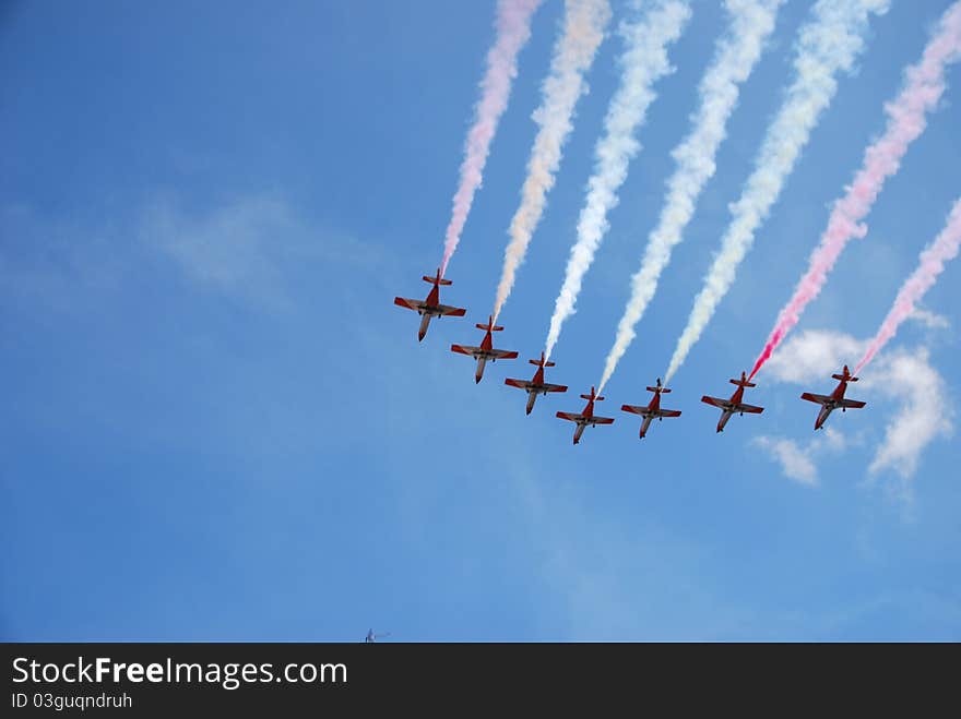 Spanish aerobatic eagle patrol in a demonstration flight over a blue sky